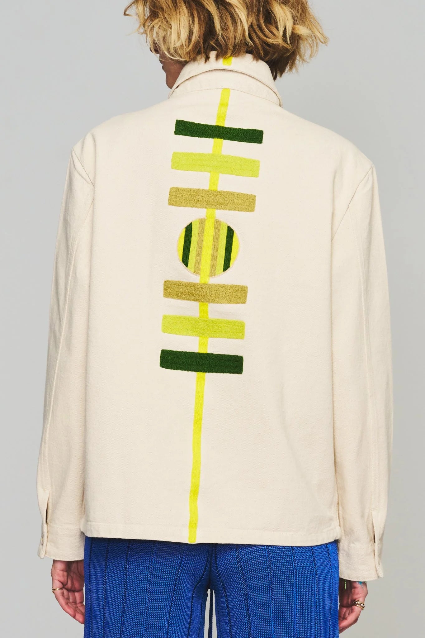 Cream chore coat with bold yellow and green back graphic stripe and circle
