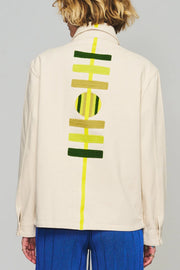 Cream chore coat with bold yellow and green back graphic stripe and circle