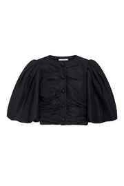 Black puff-sleeve top with ruched front and button placket