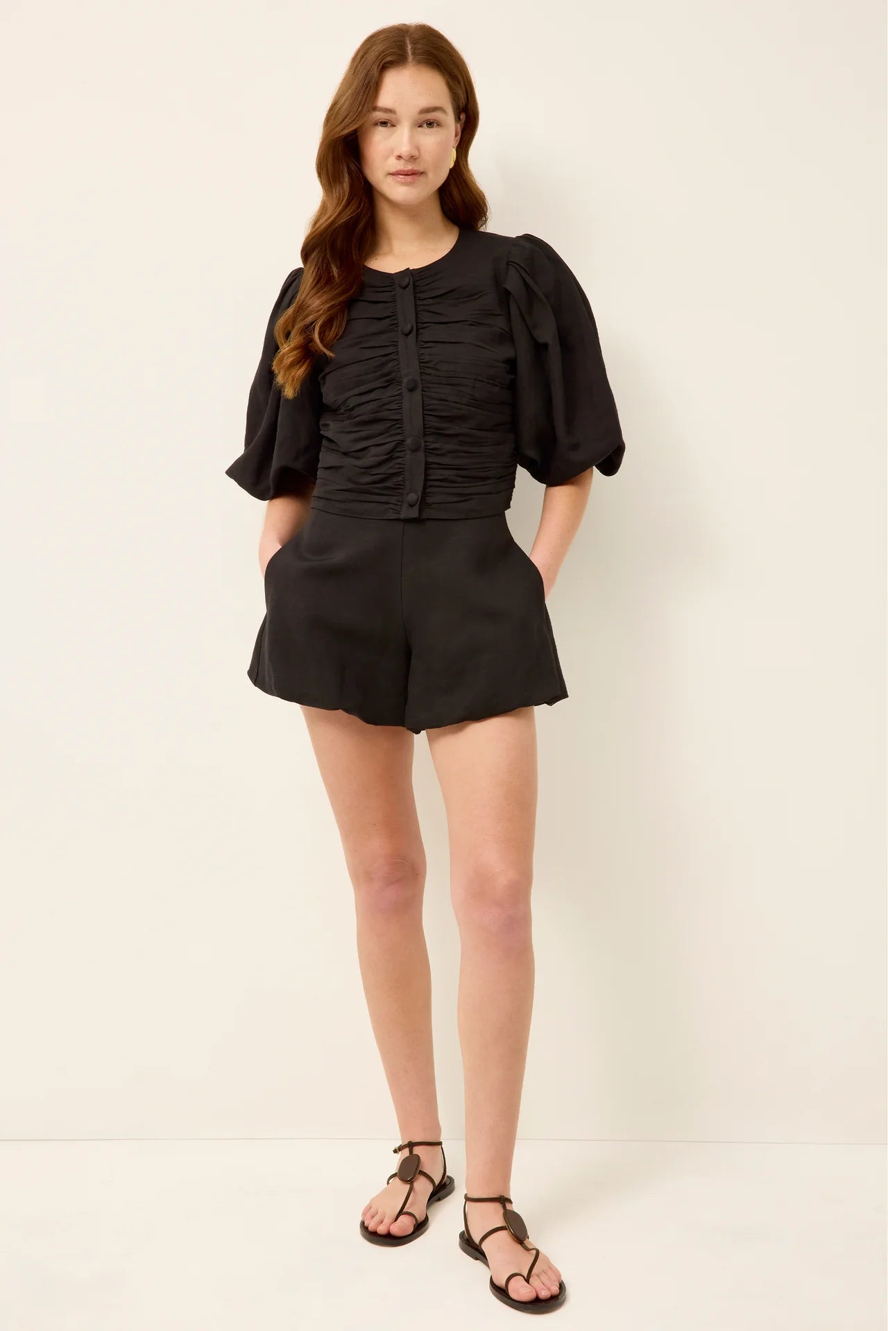 Black puff-sleeve ruched blouse with front button placket