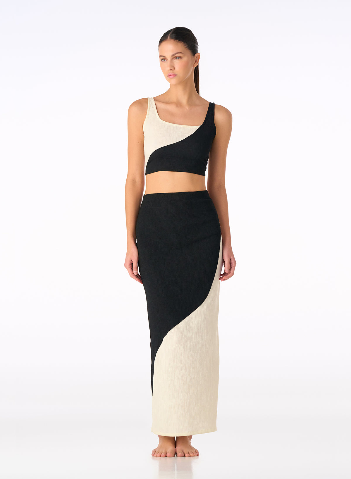 Onyx and ivory color-block knit set with sleeveless crop top and high-waist skirt