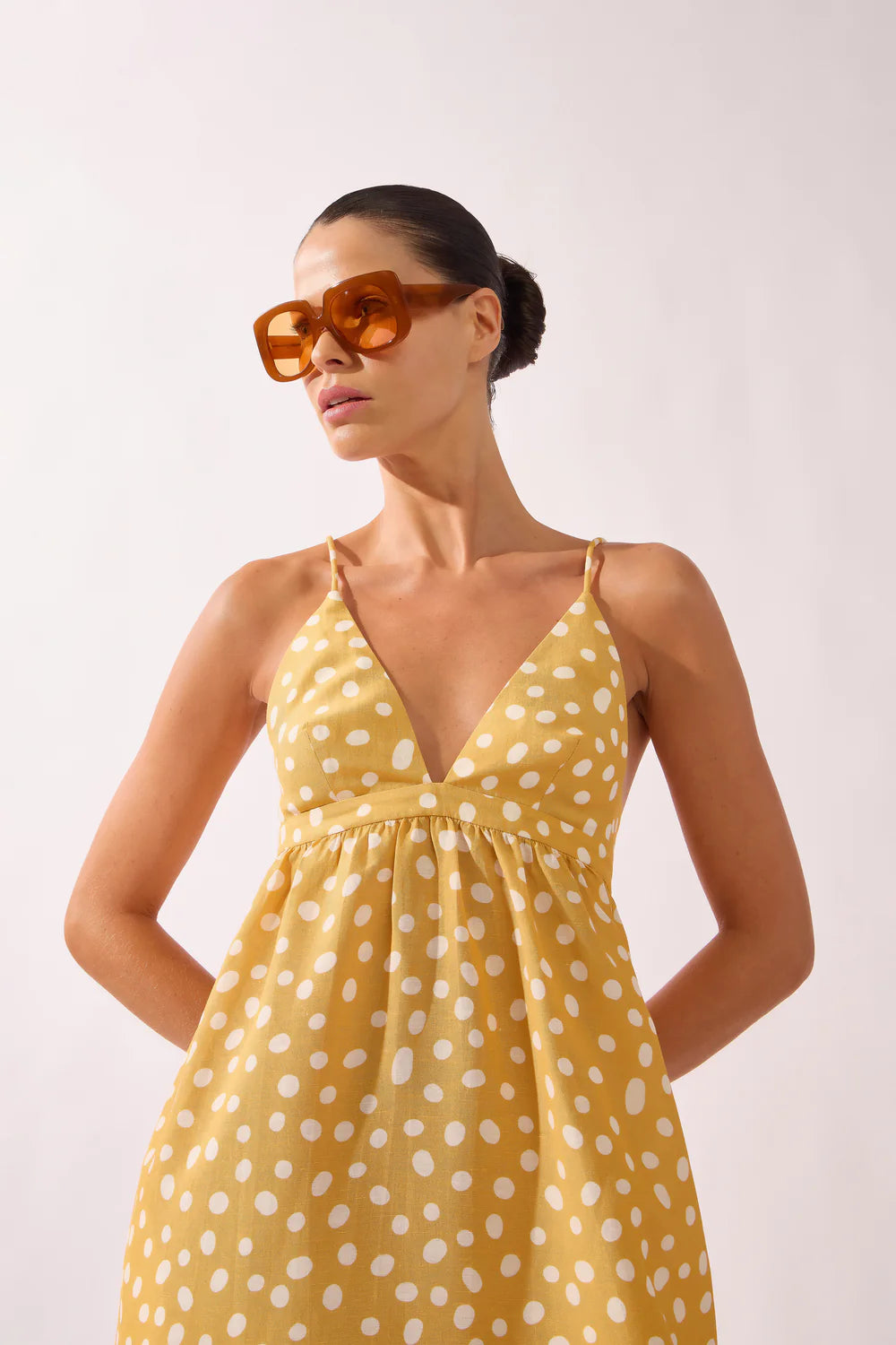 Polka dot maxi dress with V-neckline and thin straps, yellow with white dots