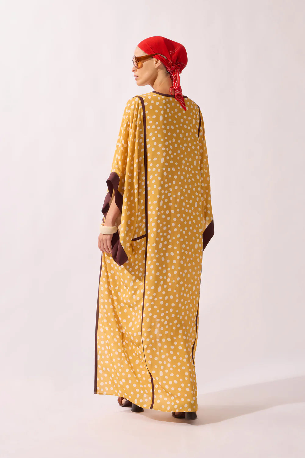 Yellow polka dot maxi kaftan back view with long panels, dark trim, wide sleeves
