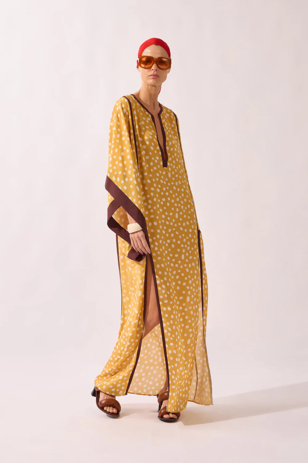 Yellow polka dot maxi kaftan with V-neck, dark trim, long open sides and wide cuffs