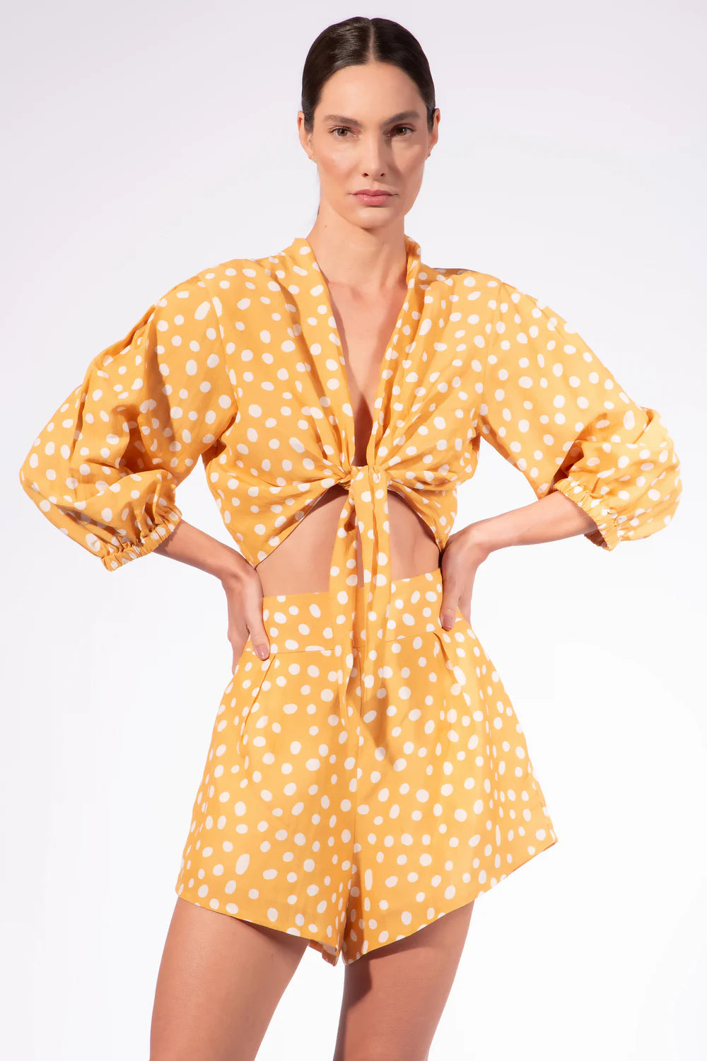 High-waisted polka dot shorts with waist tie, white dots on orange fabric