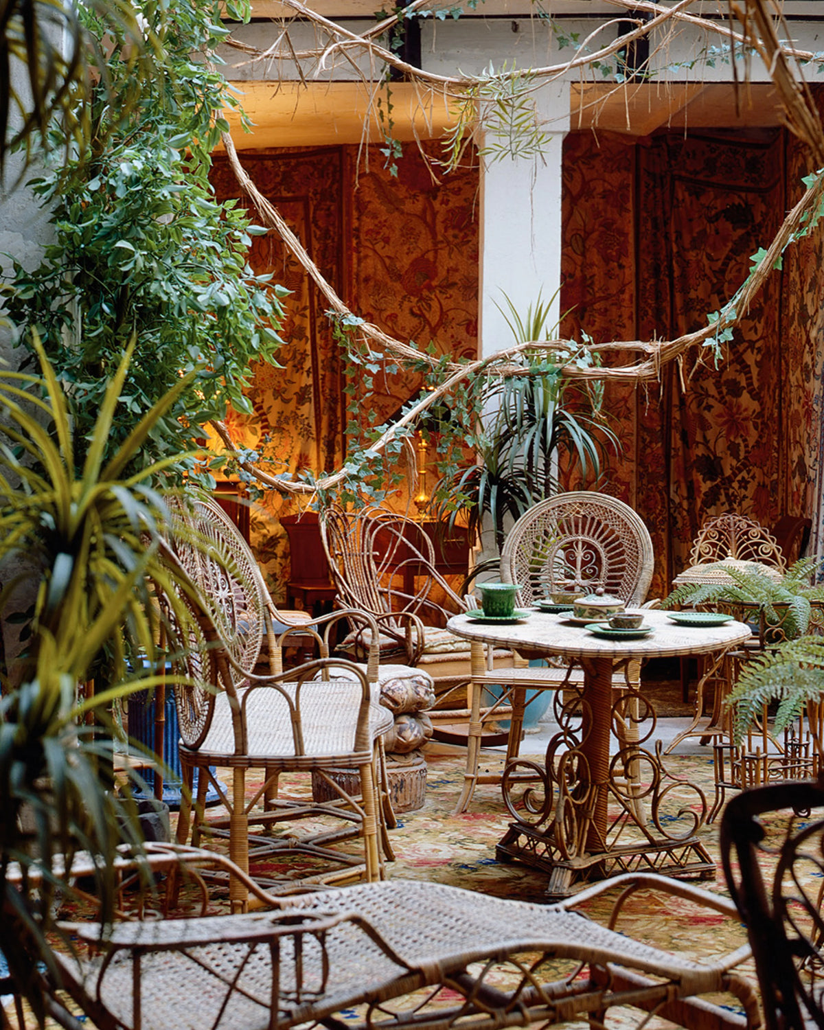Rattan book page with rattan lounge chairs and round dining table in an indoor patio
