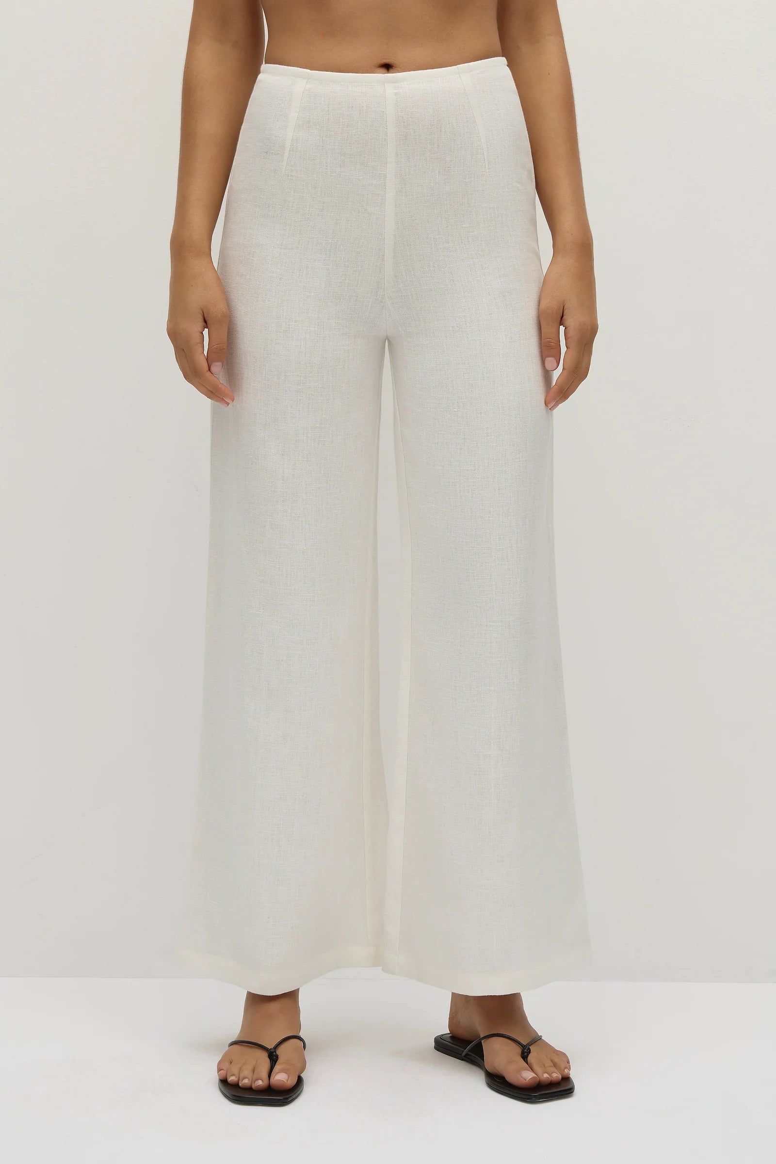 Off-white wide-leg jean pants with flat front and wide straight leg openings