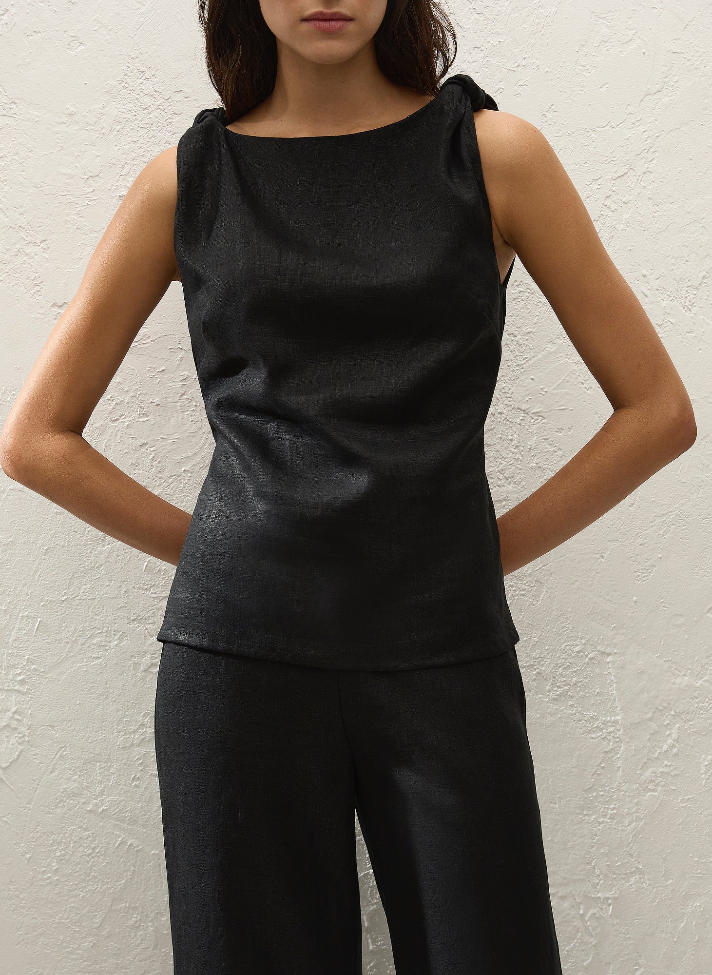 Black sleeveless top with shoulder ties and round neckline