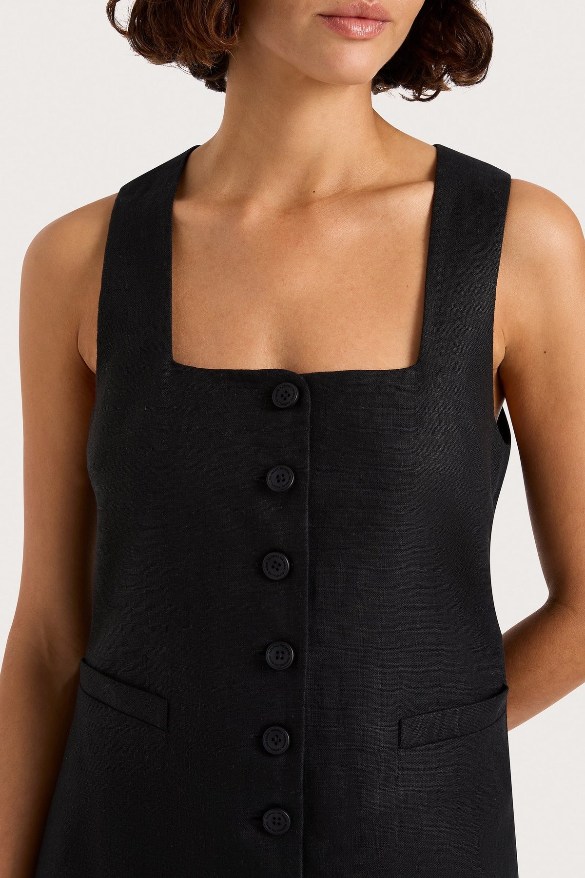 Sleeveless mini dress bodice in black with square neck and button details