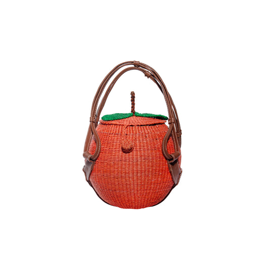Peach woven handbag with brown leather handles, orange body, green top flap