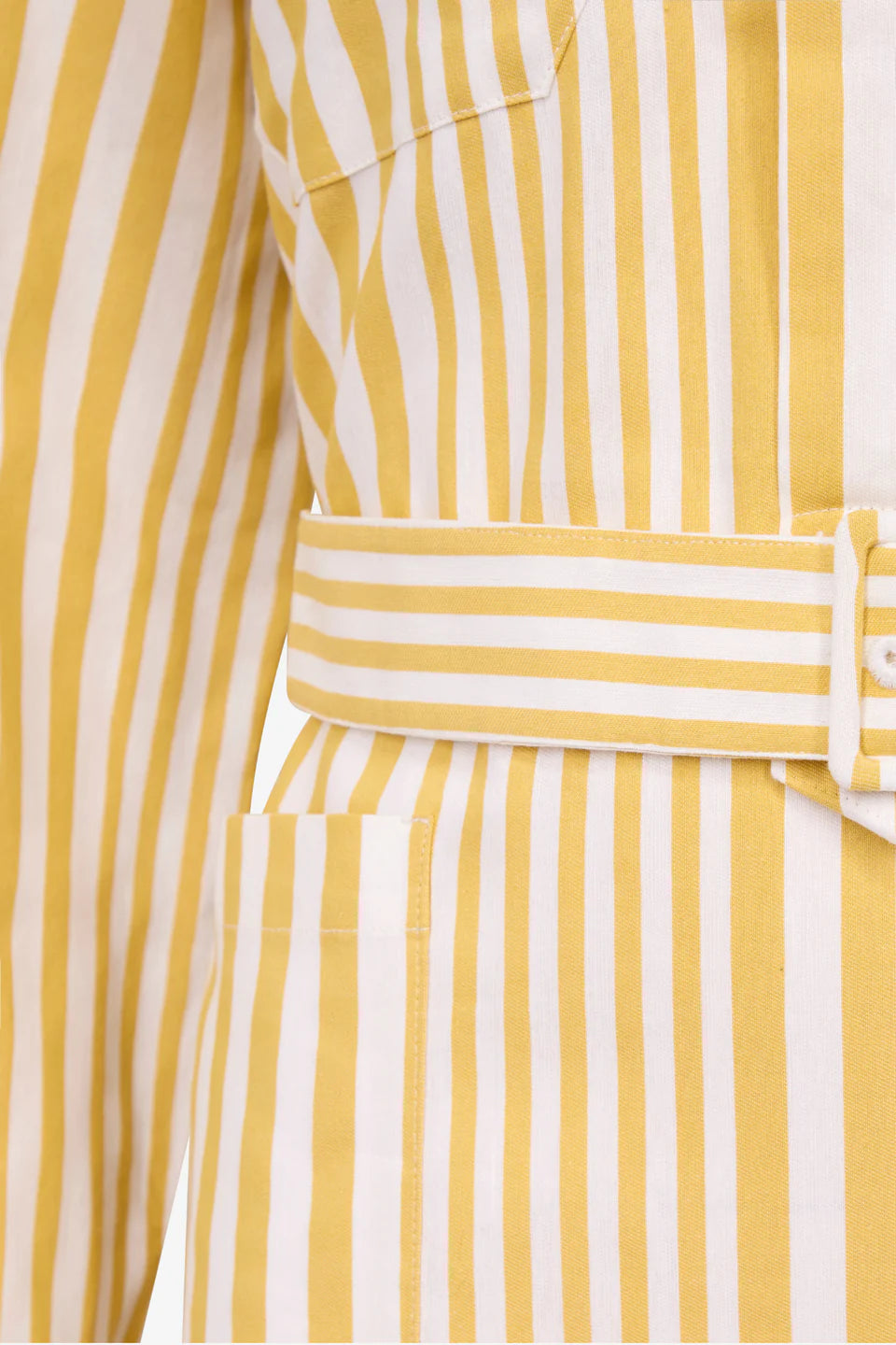 Yellow and white striped fabric closeup with belted waist and buttoned placket