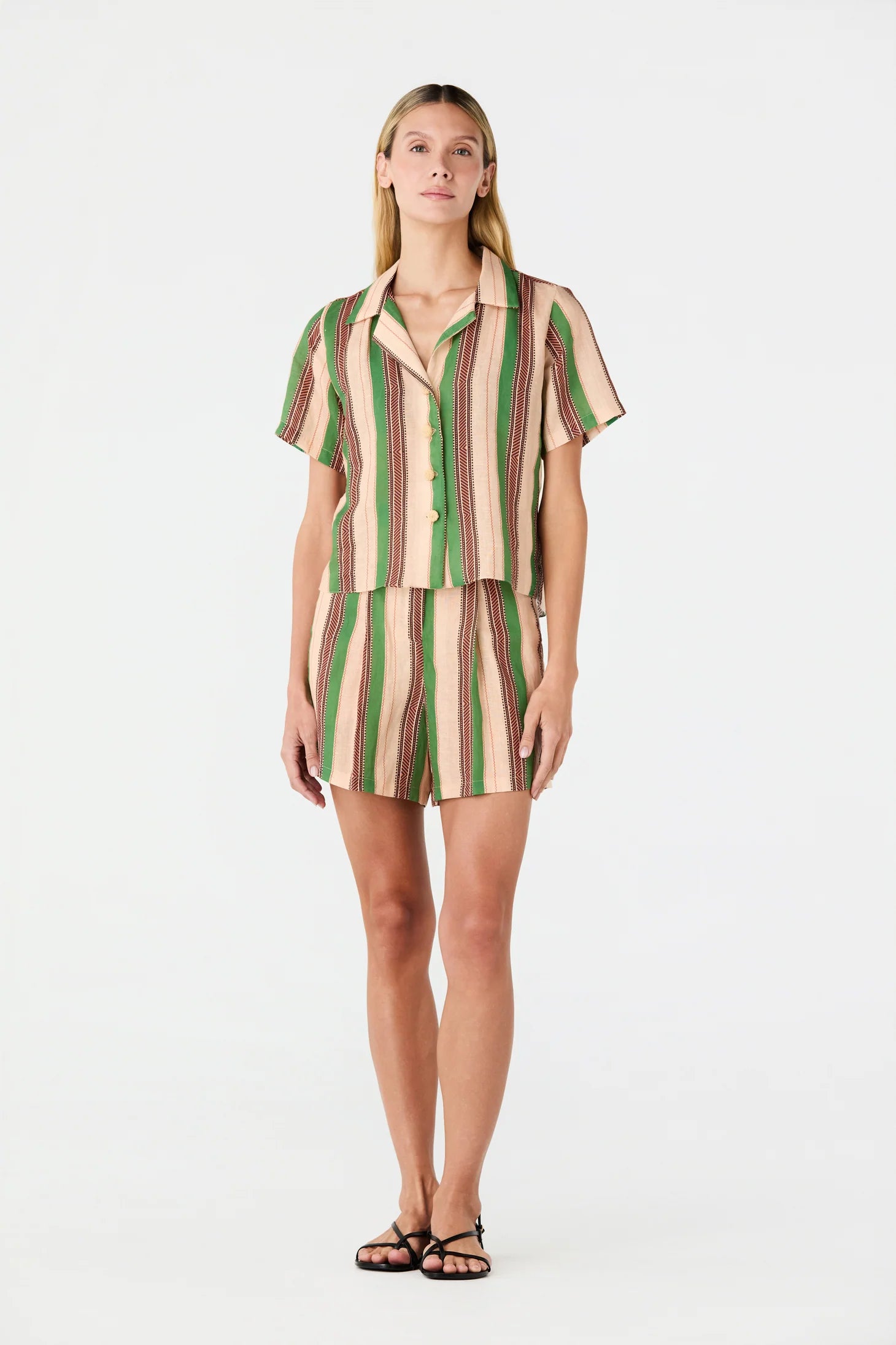 Linen shirt on model, green vertical and beige striped short-sleeve button-up.
