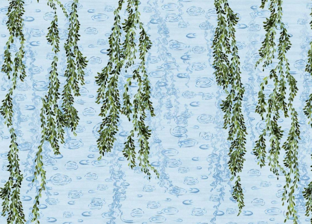 Light blue poplin close-up with green trailing floral-vine print and subtle blue swirl pattern.