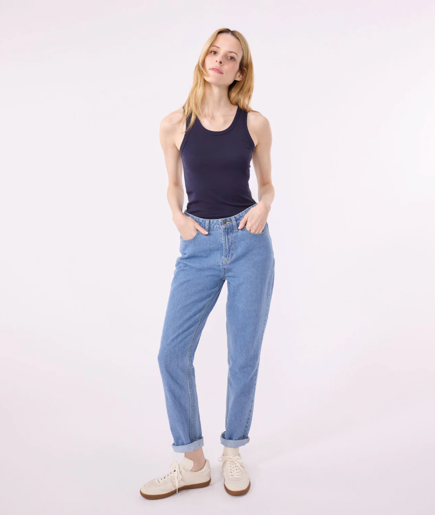 Black sleeveless tank top with scoop neckline, worn with light blue jeans