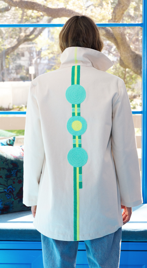 White hooded jacket with green-and-turquoise vertical back graphic