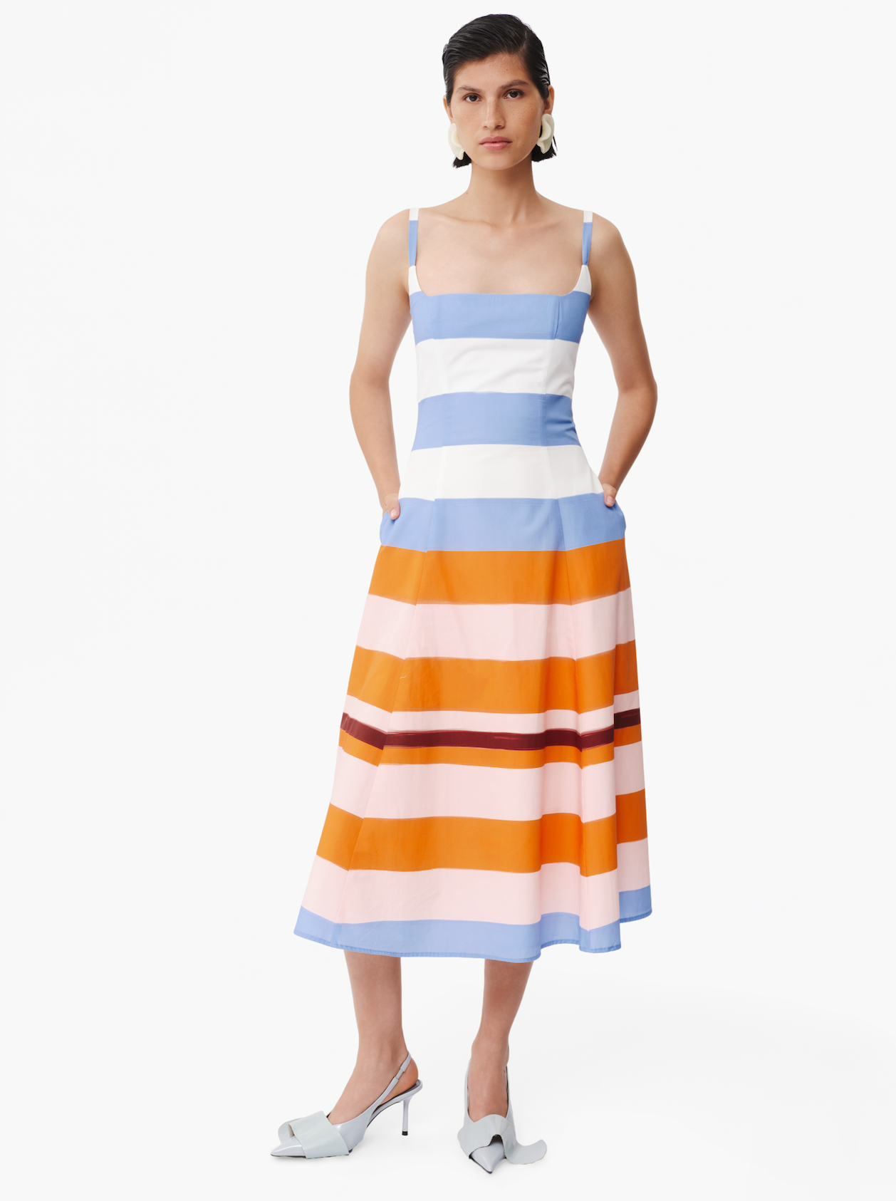 Striped midi dress on model: blue-and-white bodice, orange striped skirt, spaghetti straps