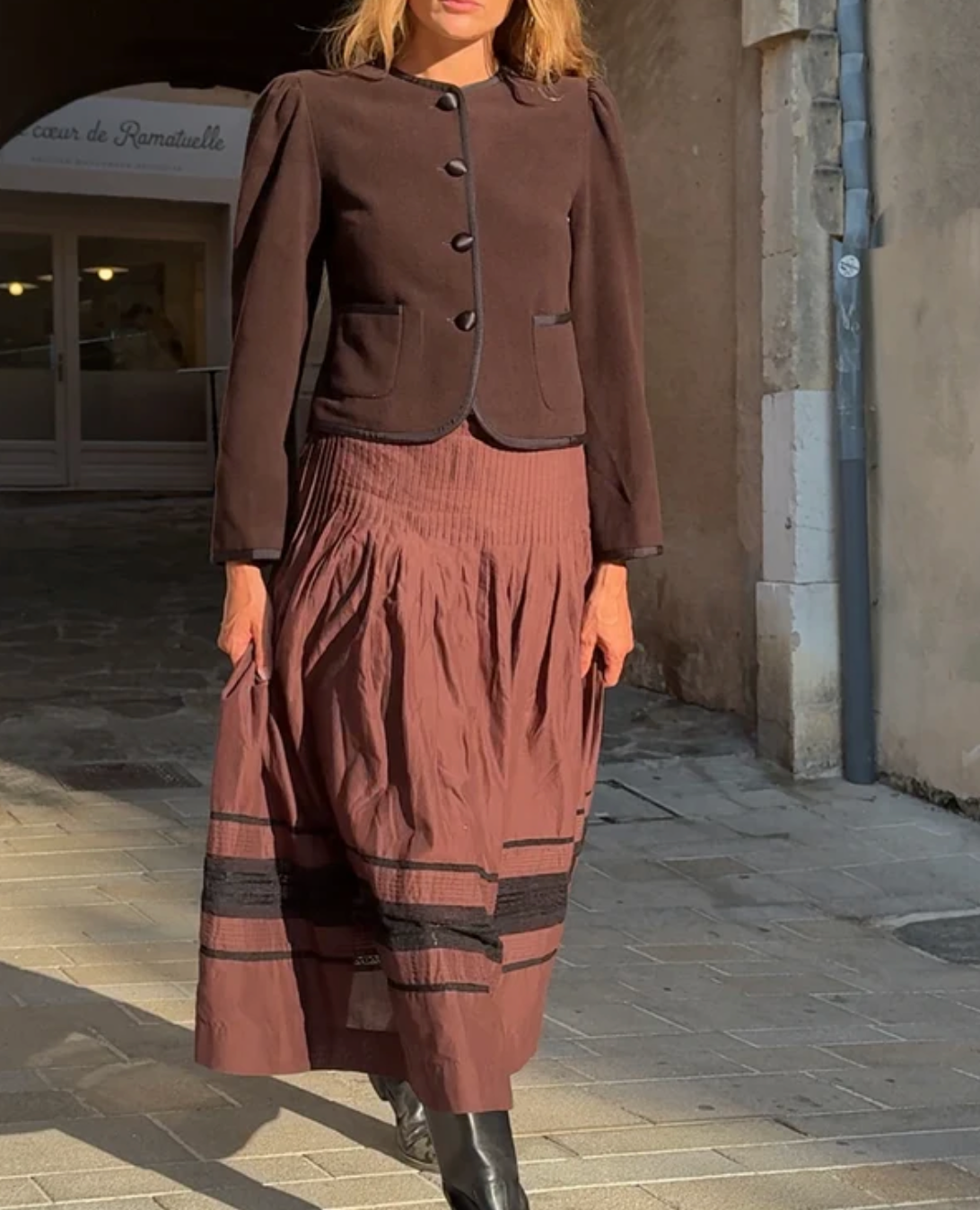Women's brown button-front coat with flap pockets and gathered shoulders, long sleeves