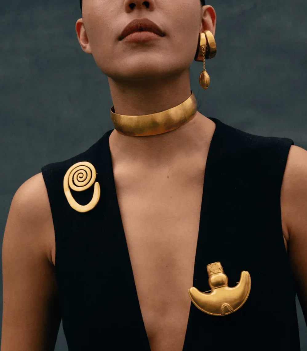 Gold sculpted choker necklace with curved matte band at the neck