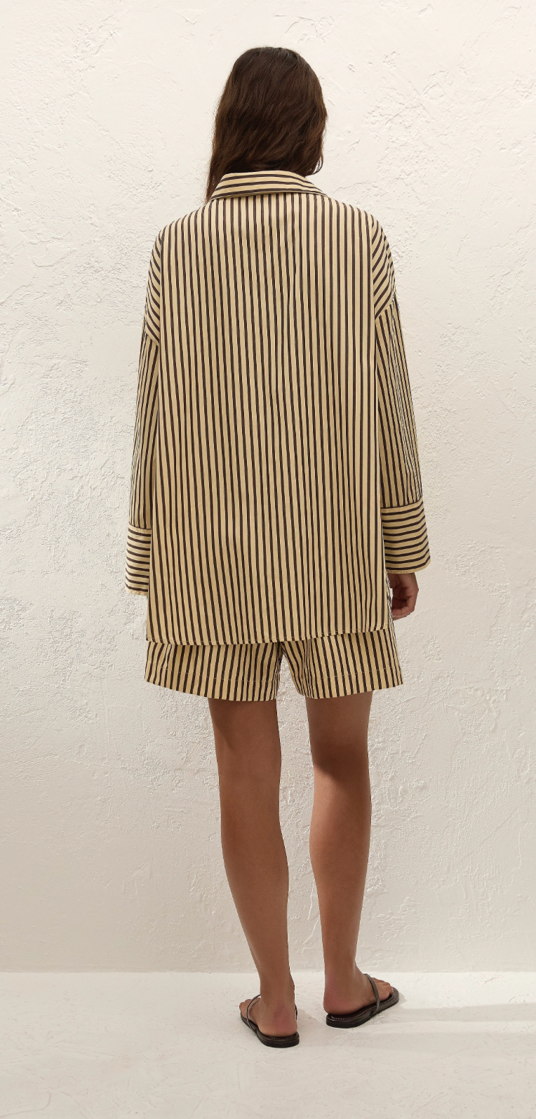 Clemente shorts back view, vertical tan and black stripes, elastic waistband