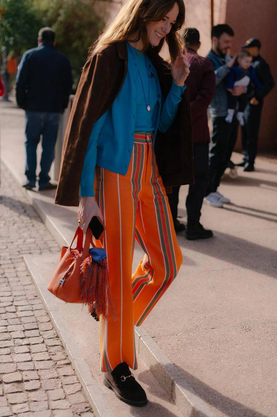 Orange striped pants with green and red vertical stripes, belt loops and pockets