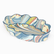Scalloped desk tray with blue, white, and multicolor abstract marbled pattern