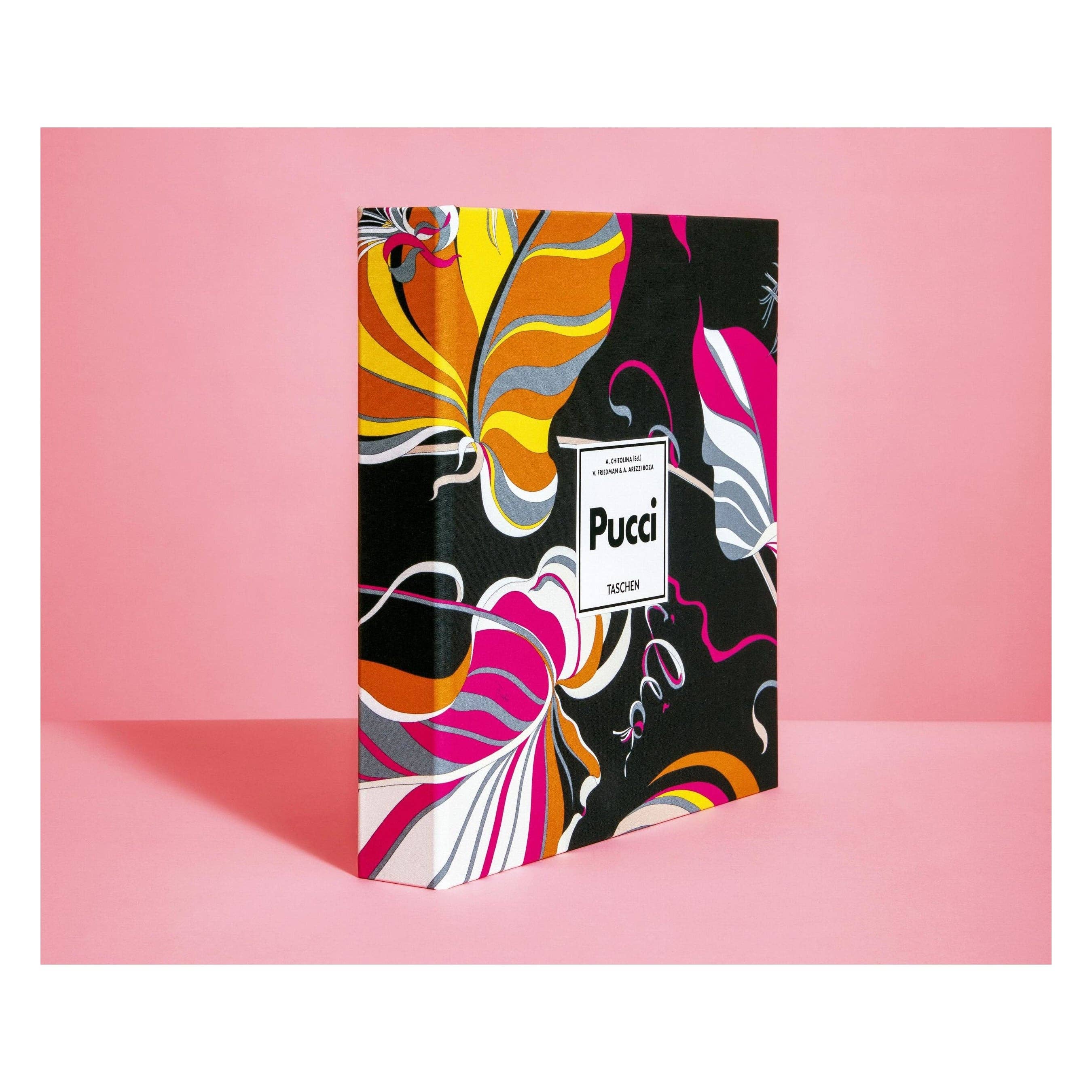 Pucci fashion book, upright angled view with abstract multicolor cover art and logo.