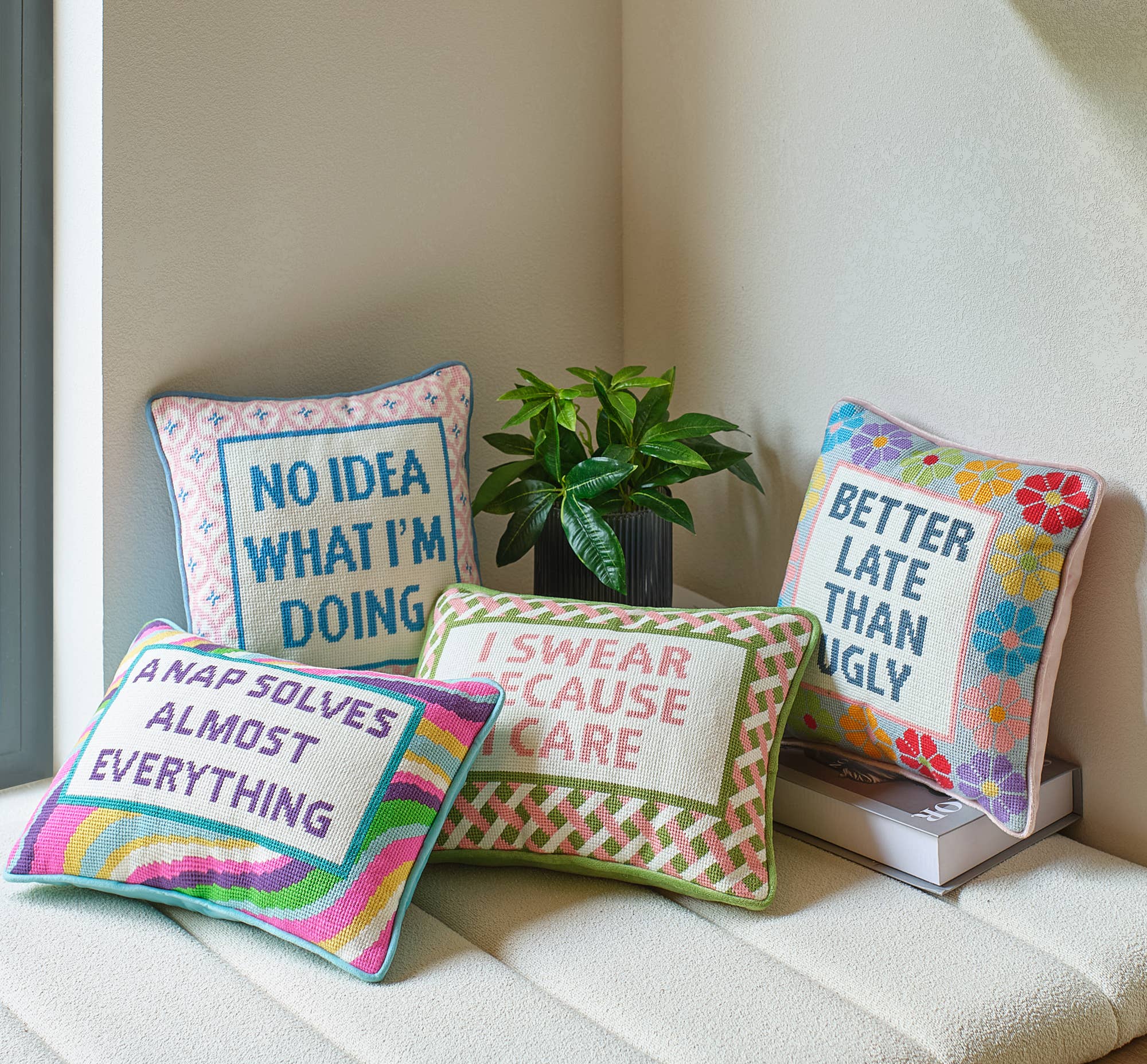 Embroidered throw pillow reading 'I SWEAR BECAUSE I CARE' with patterned trim