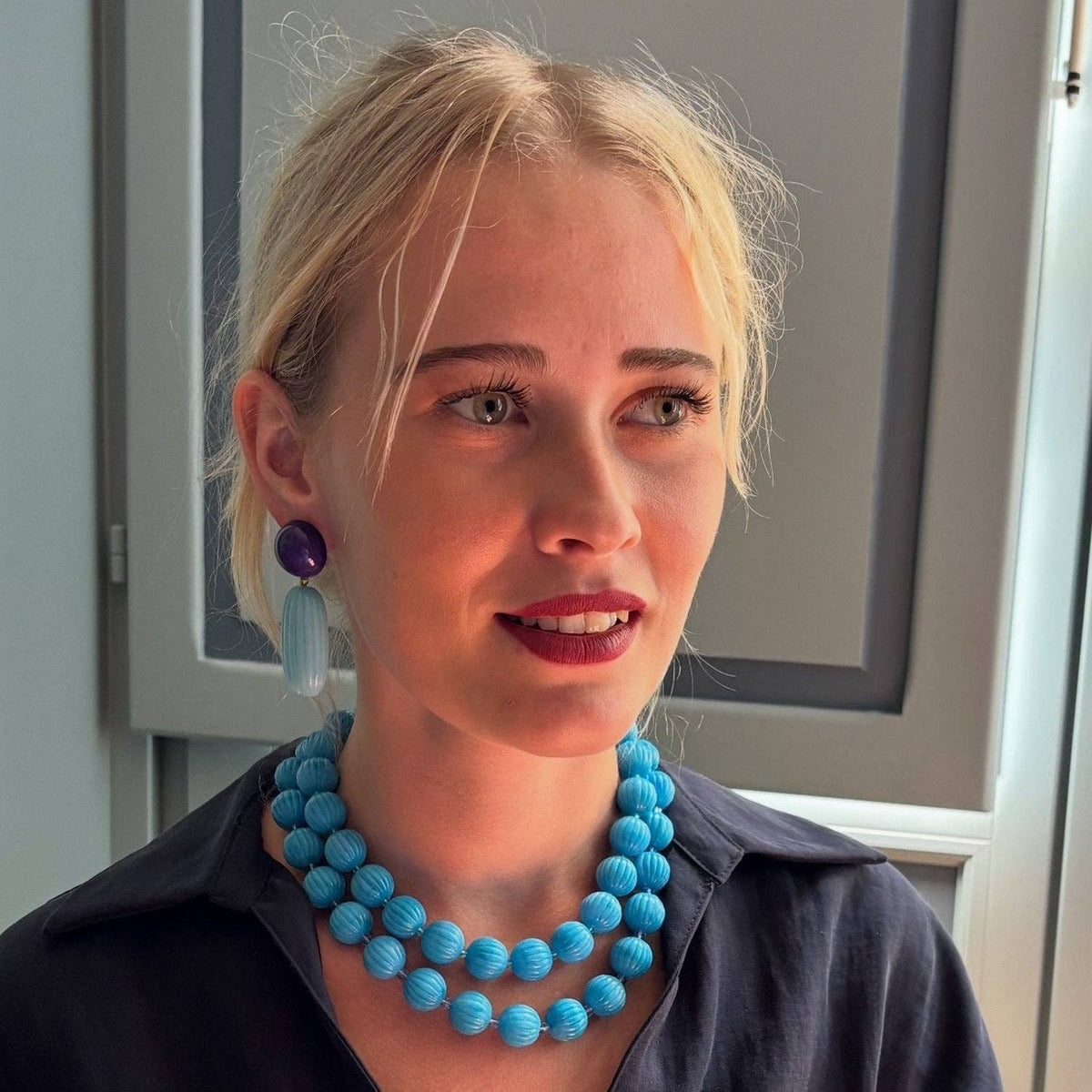 Turquoise carved melon bead necklace worn with a short bead collar look
