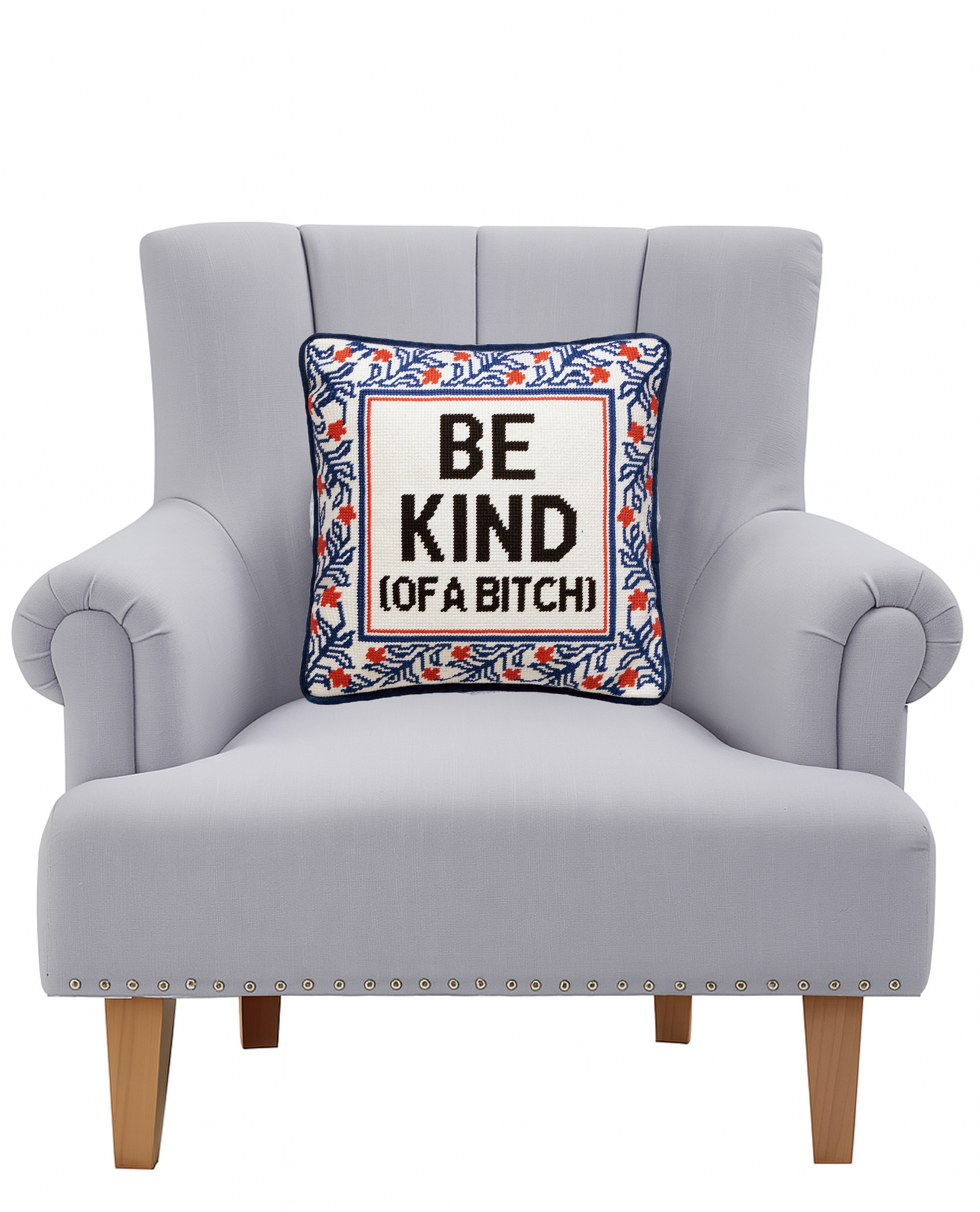 Embroidered pillow with navy border, red accents, and "BE KIND (OF A BITCH)"