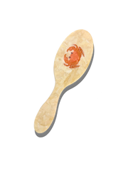Crab hairbrush with pale wood-look handle and raised crab design on brush pad
