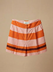 Striped shorts in orange and white with wide horizontal bands and elastic waistband