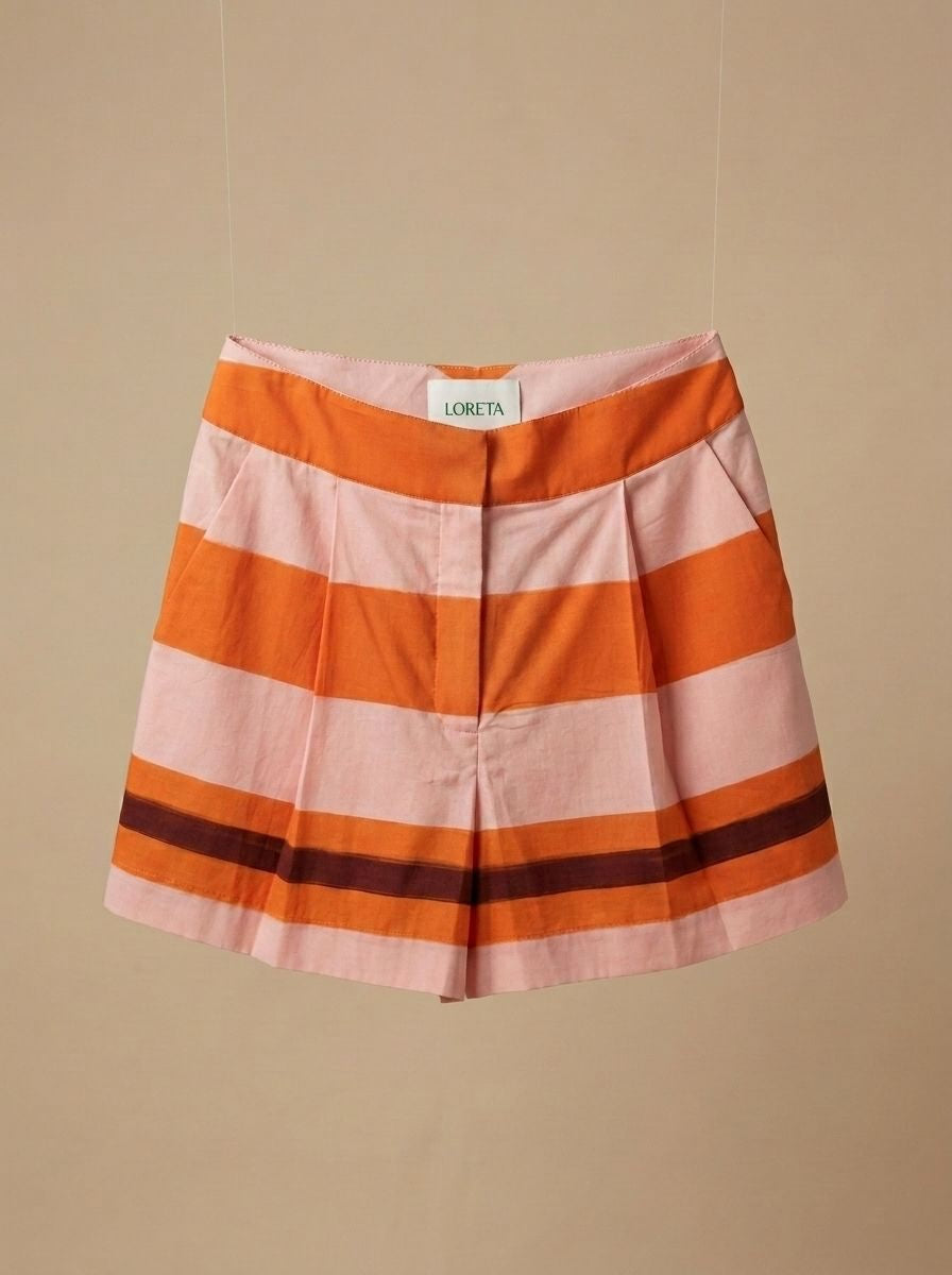 Striped shorts in orange and white with wide horizontal bands and elastic waistband