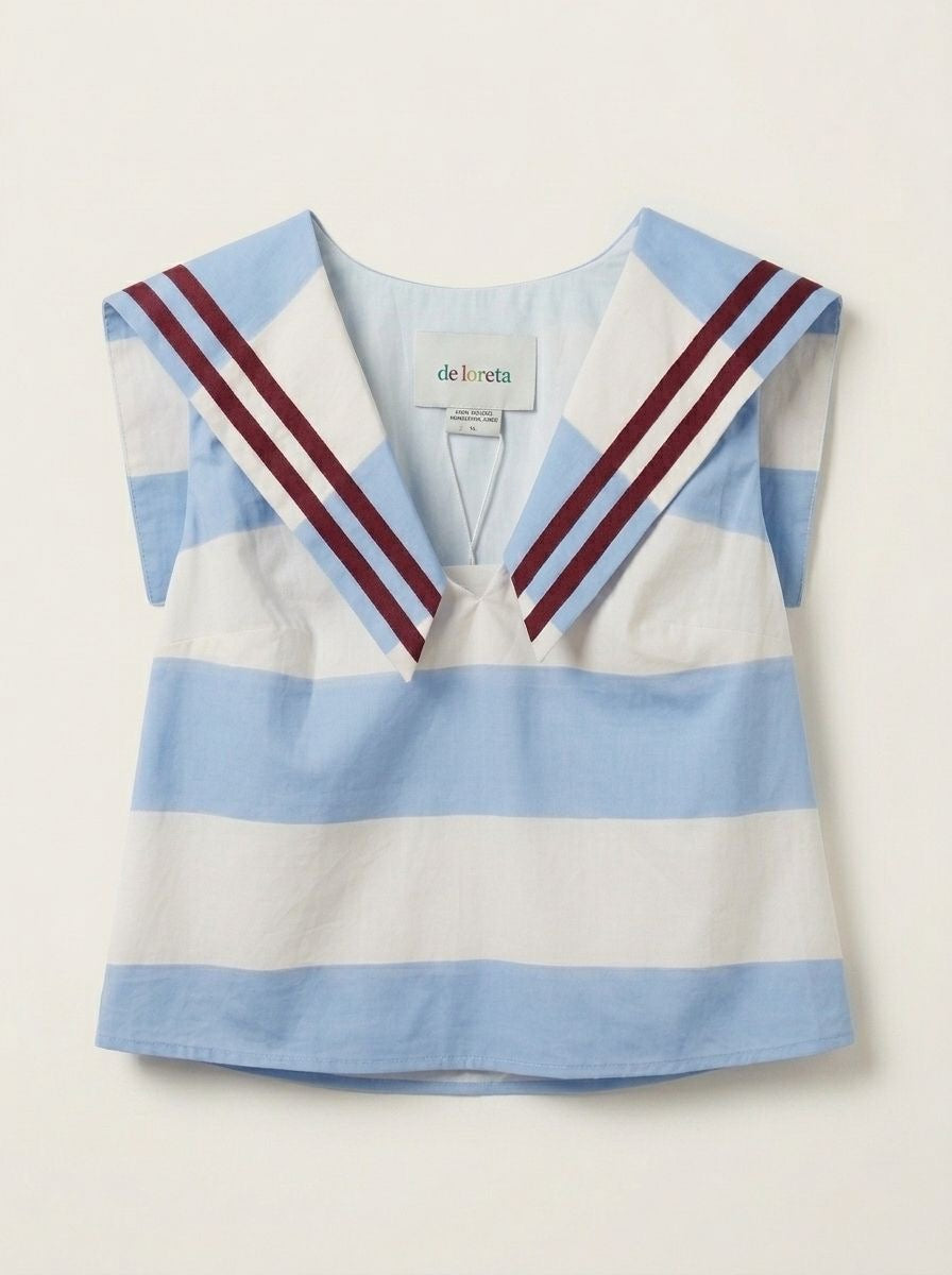 Sleeveless striped top with blue-and-white bands, V-neck, and red shoulder stripes