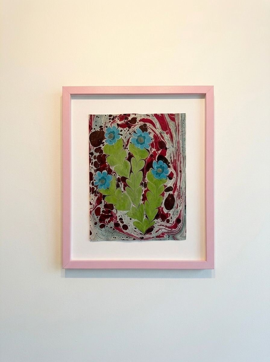 Framed flower painting with maroon marbled background, teal blossoms, green leaves and stems