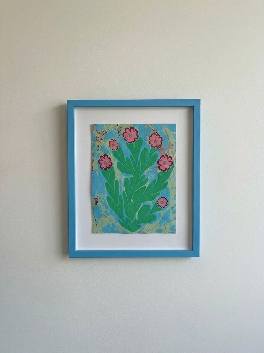 Framed original flower painting with pink blossoms and green leaves on blue background