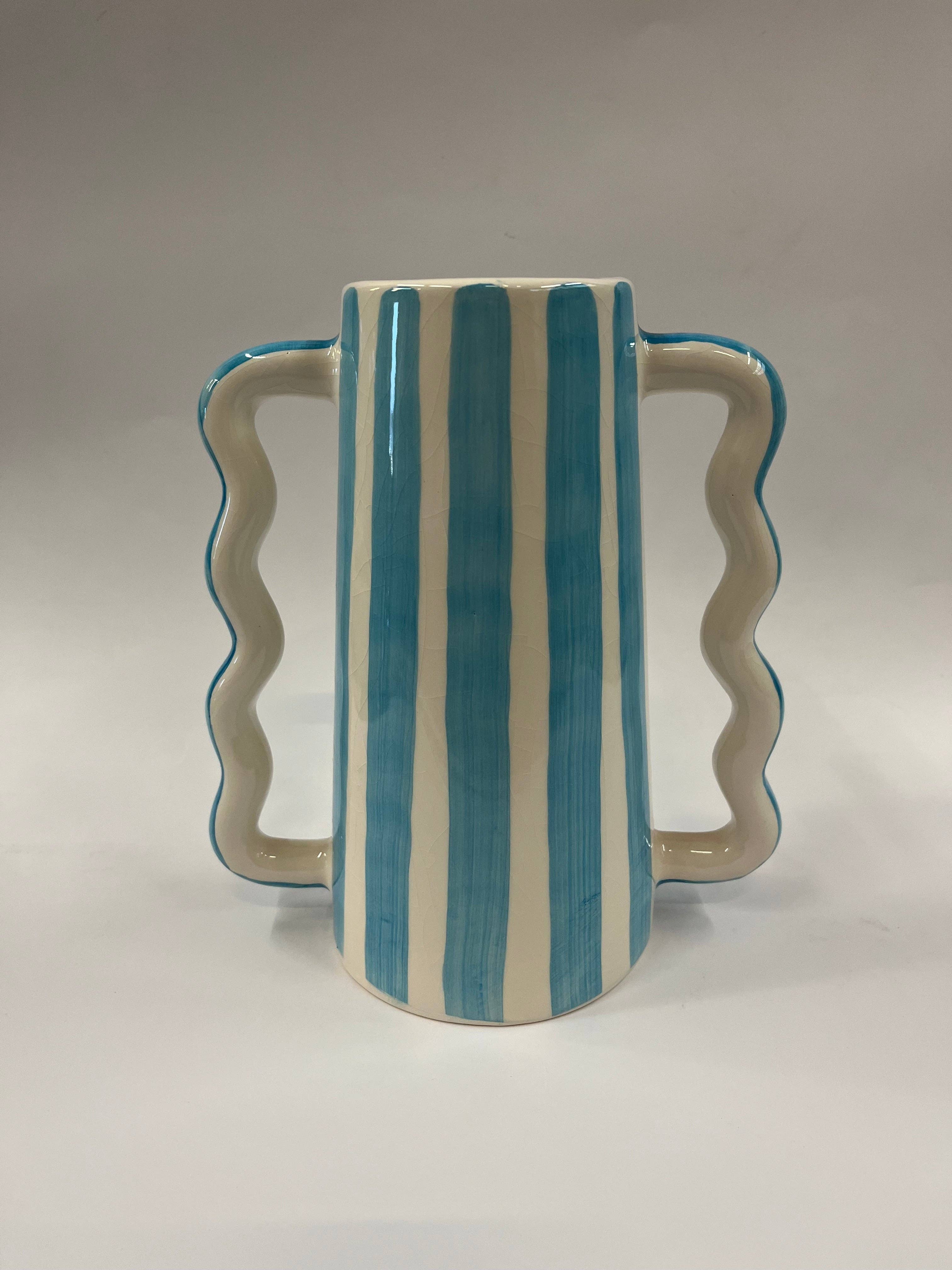 Small ceramic vase with wavy side handles and blue vertical stripe pattern