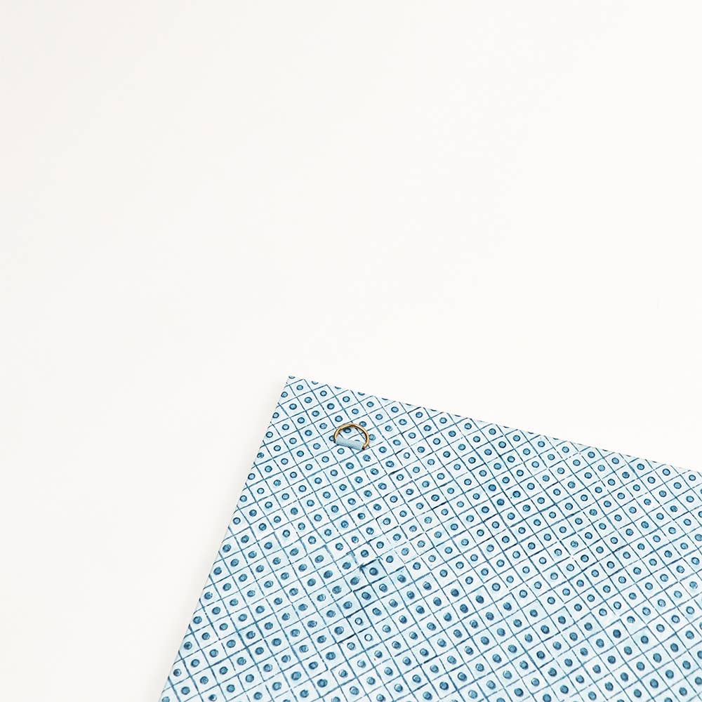 Blue trellis-patterned back of wall picture frame, corner detail