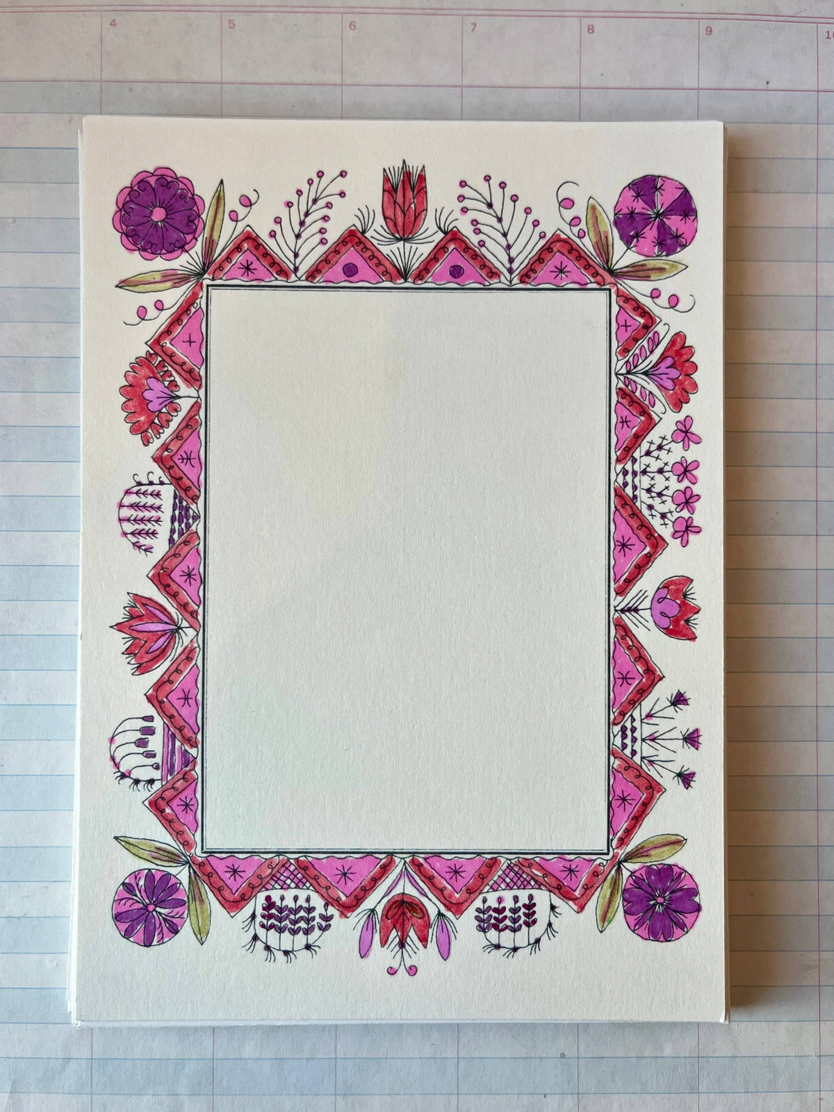 Decorative folk picture frame with pink/purple floral border and diamond corner accents