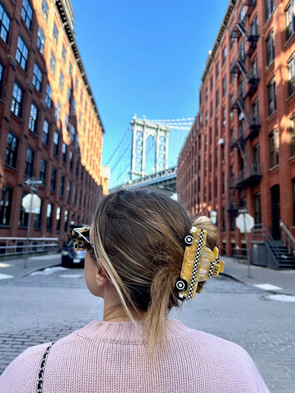 Yellow taxi cab claw hair clip with checkered stripe, clipped on light hair
