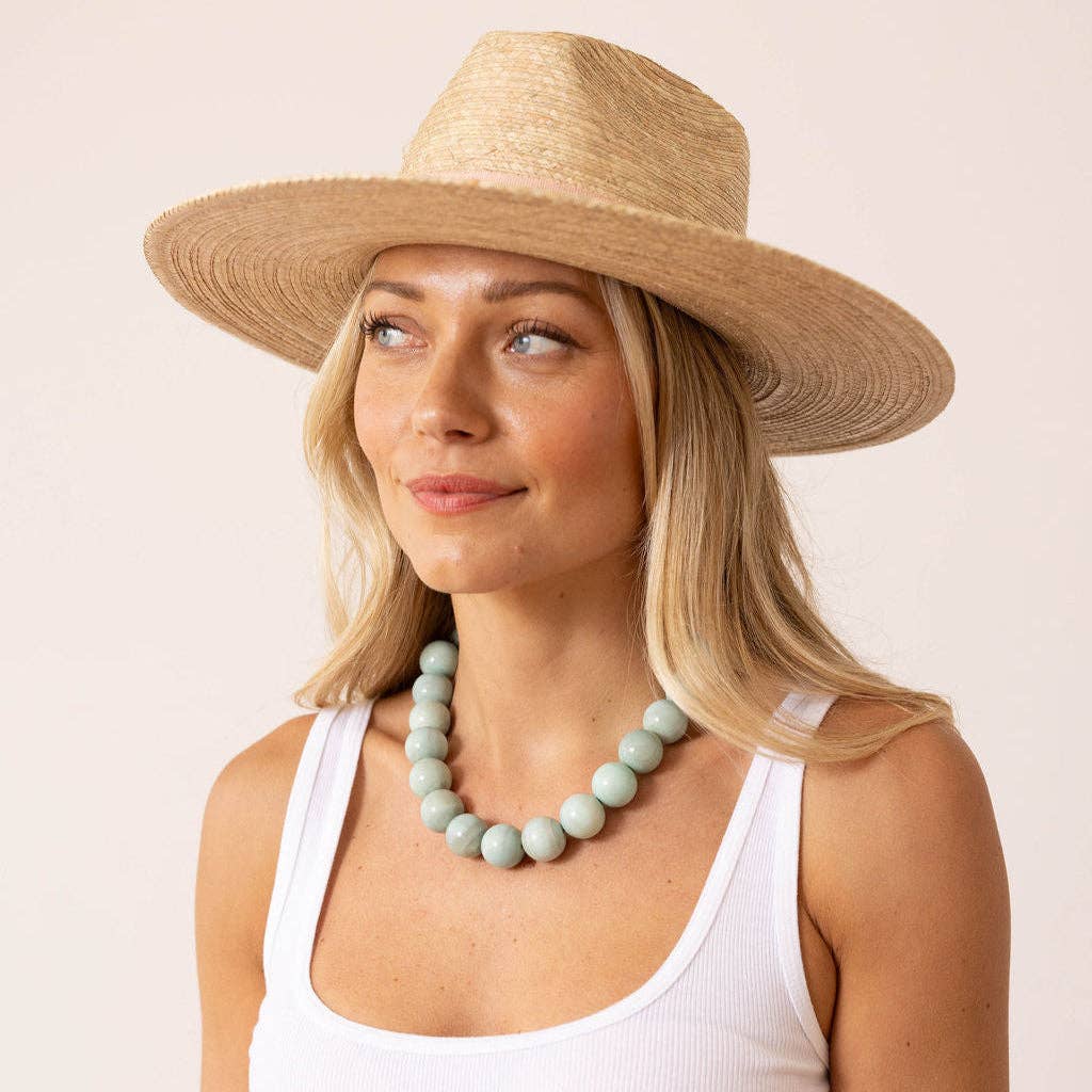 Pastel green gumball beaded necklace with round beads, worn around the neck