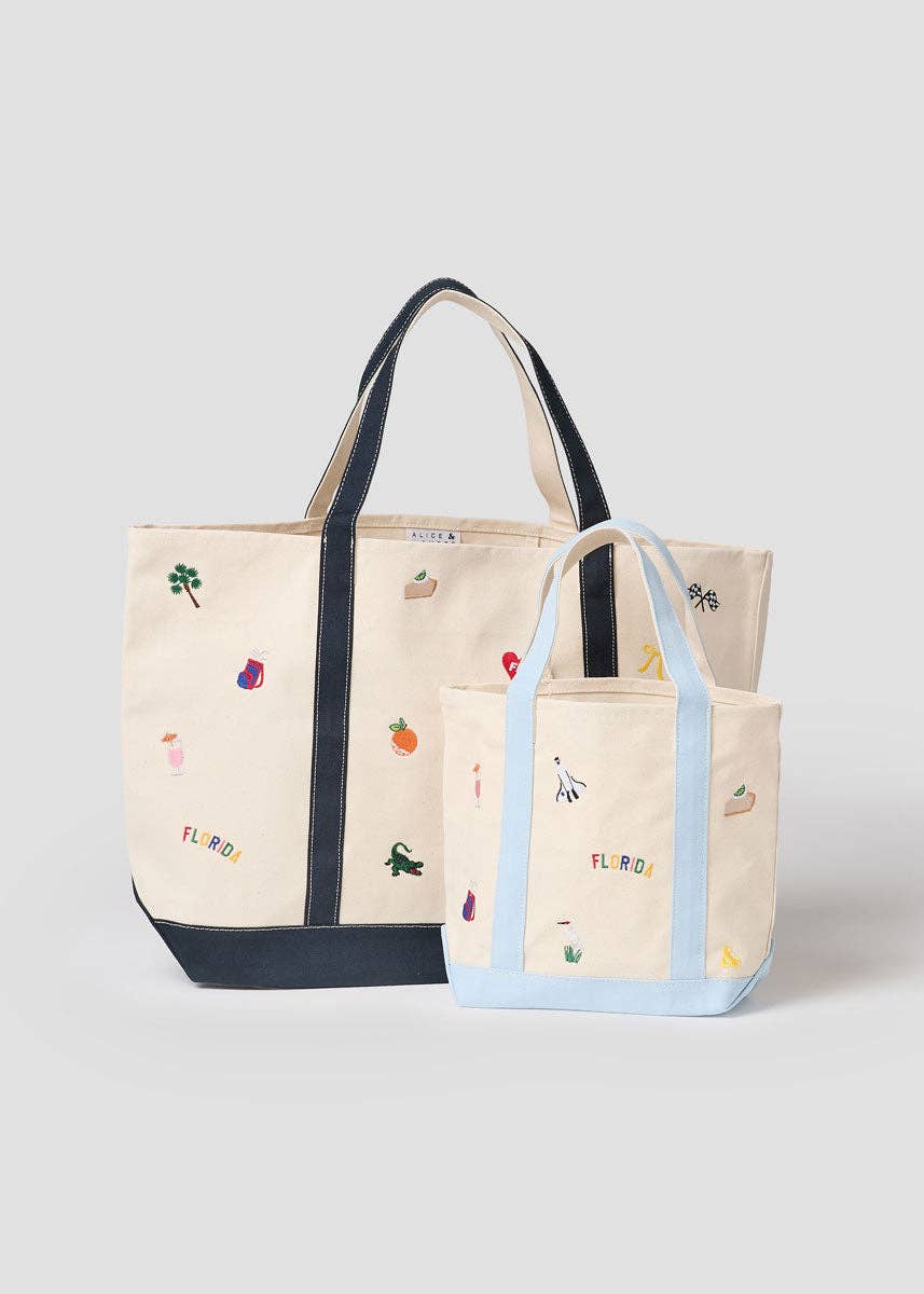 Two small canvas tote bags with Florida icons: navy and light-blue handles