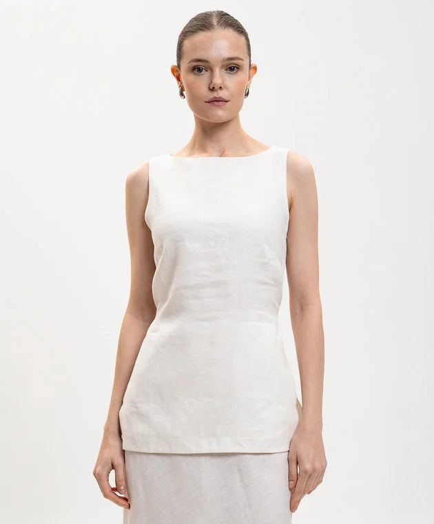White sleeveless top on model, round neckline and fitted straight silhouette