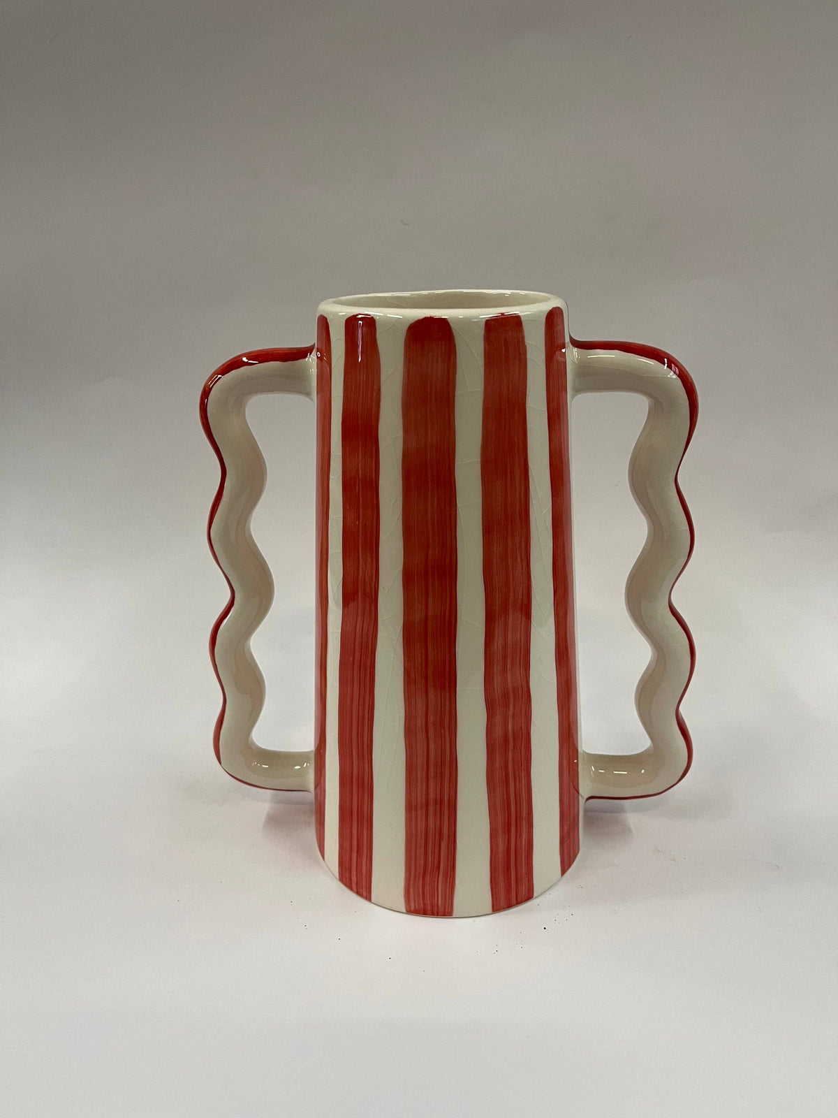 Small ceramic vase with wavy side handles and red vertical stripe pattern