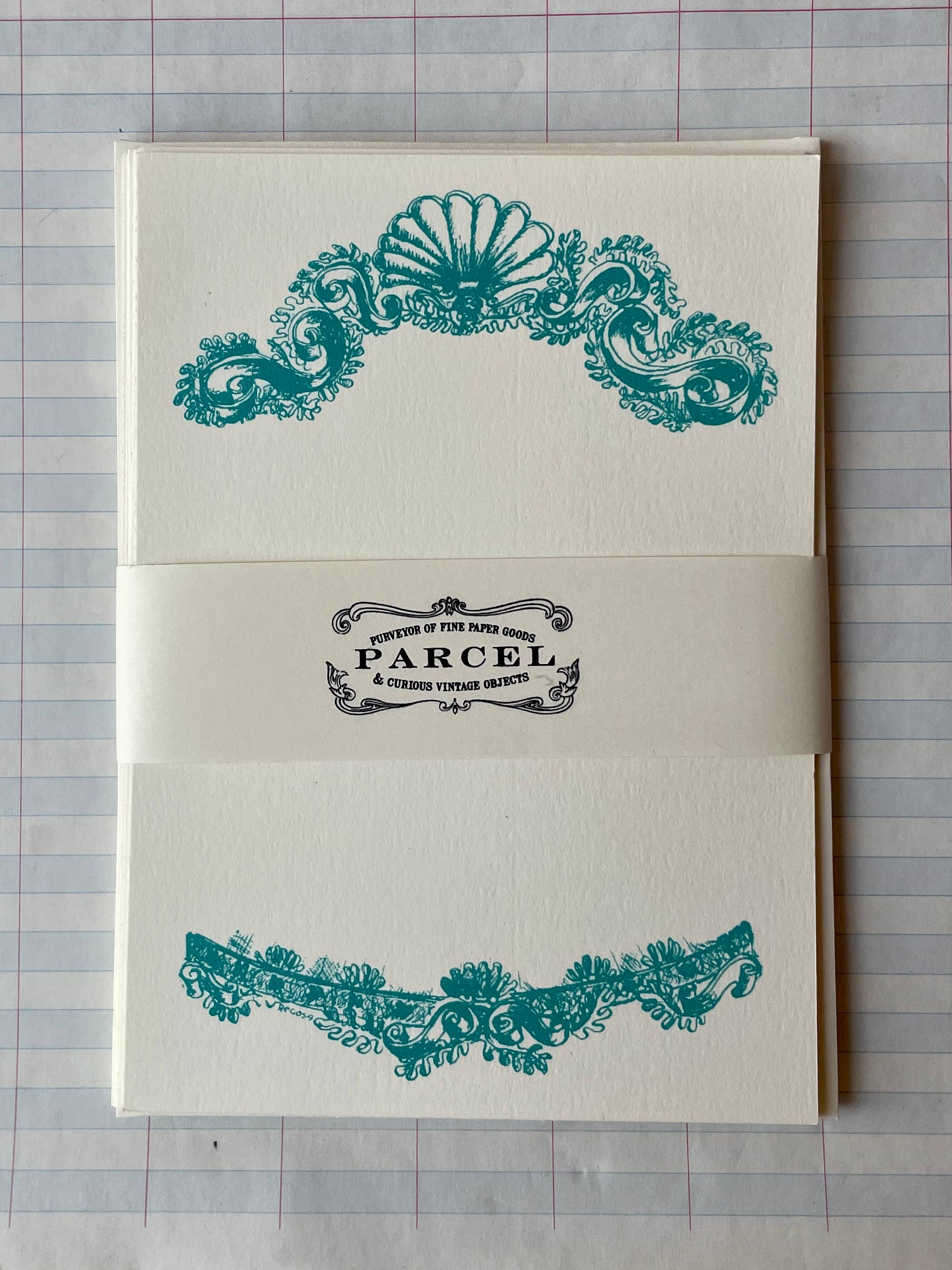 Shell banner with teal ornate shell scroll design and PARCEL label on cream paper