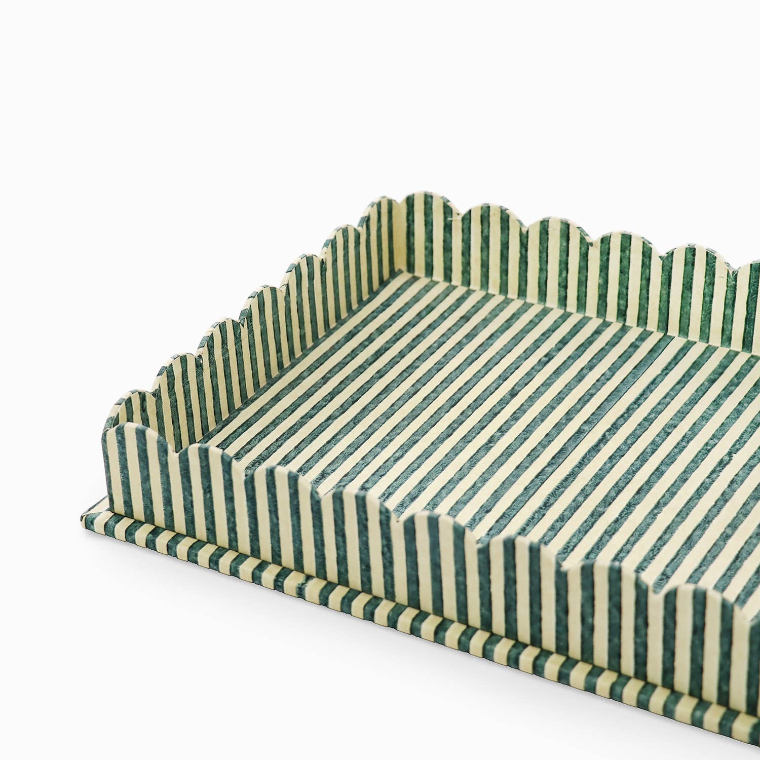 Large scalloped serving tray close-up, striped green and white with scalloped rim.