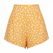 High-waisted polka dot shorts with white dots on orange, pleated front