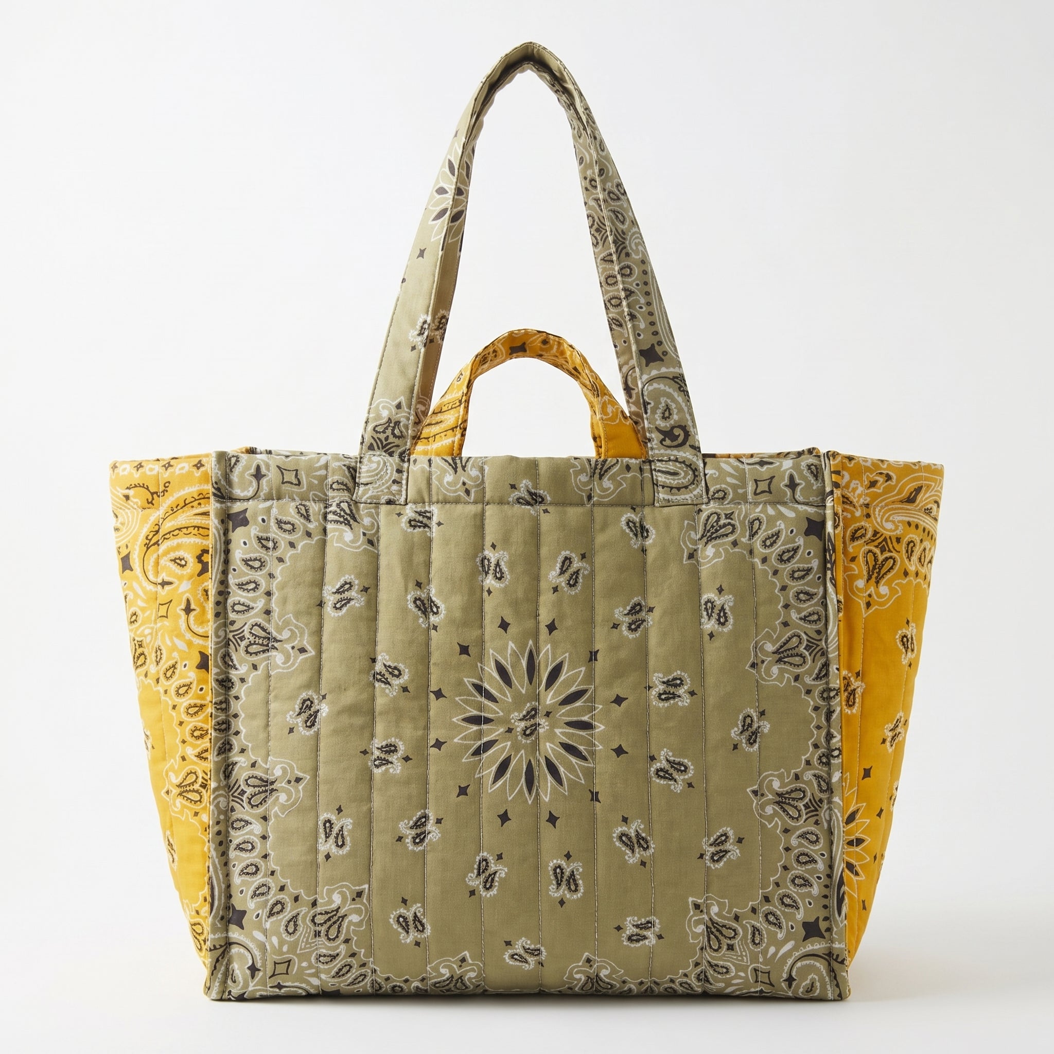 Quilted tote bag with paisley print, olive center panel, mustard side panels.