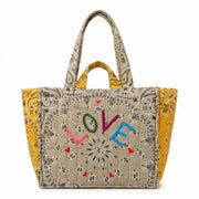 Quilted cabas tote with yellow sides and LOVE doodle print, patterned handles