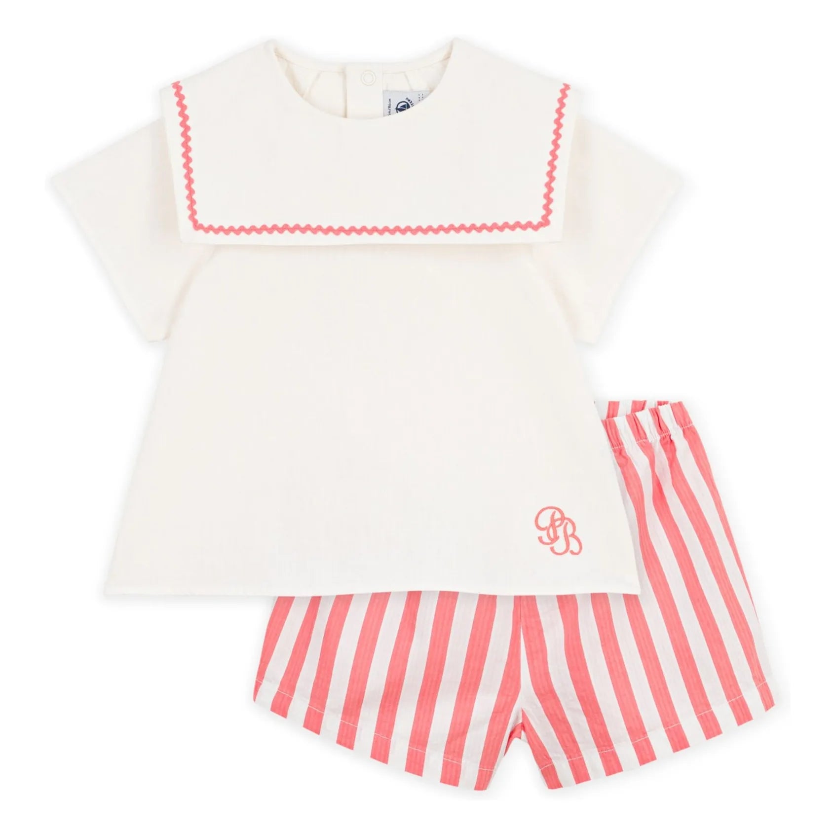 Side view cream sailor top with pink zigzag trim and striped pink-and-white shorts