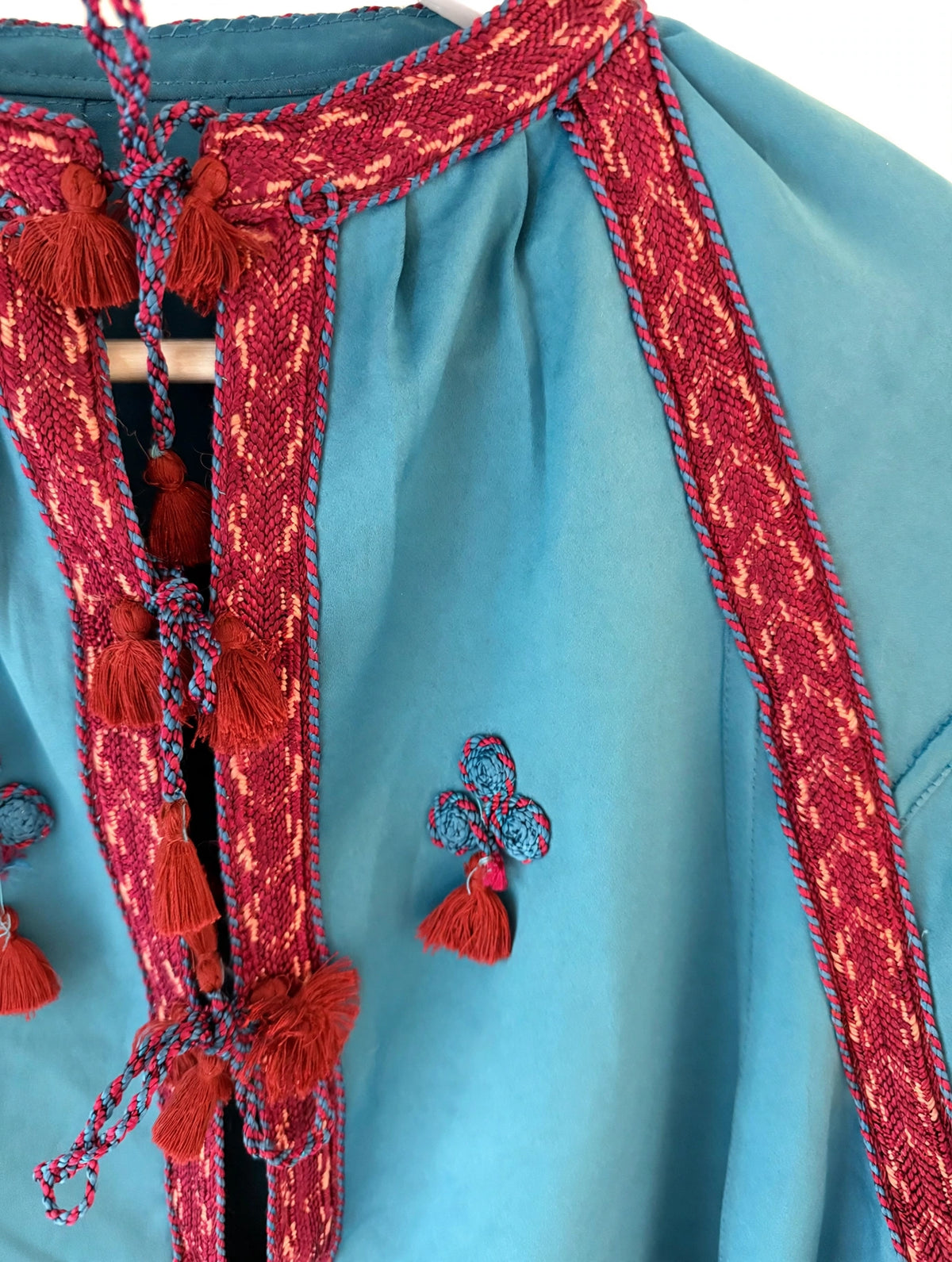 Teal silk kaftan mini dress with red embroidered tassel neckline and trim